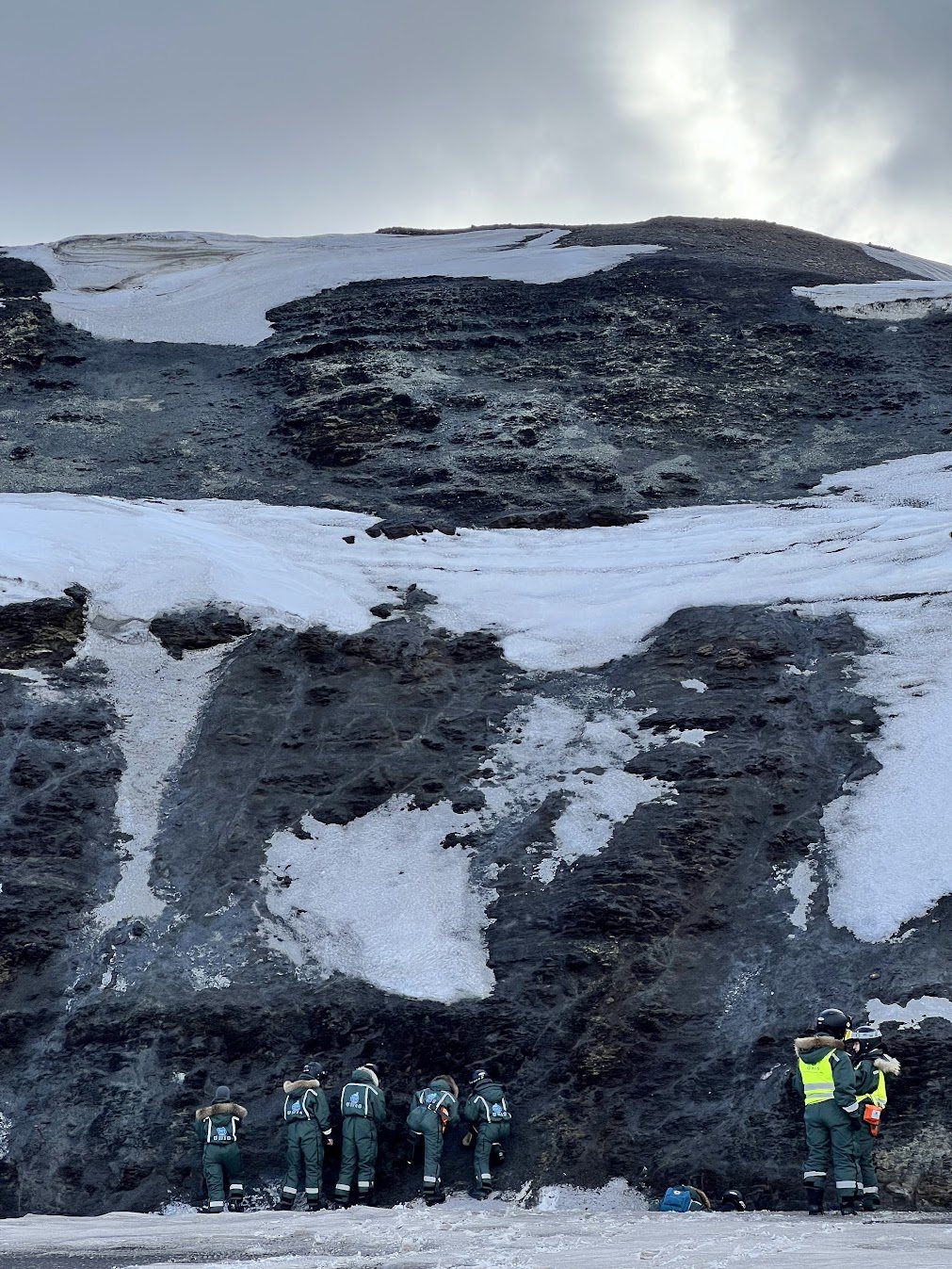 Students examining an outcrop in the field